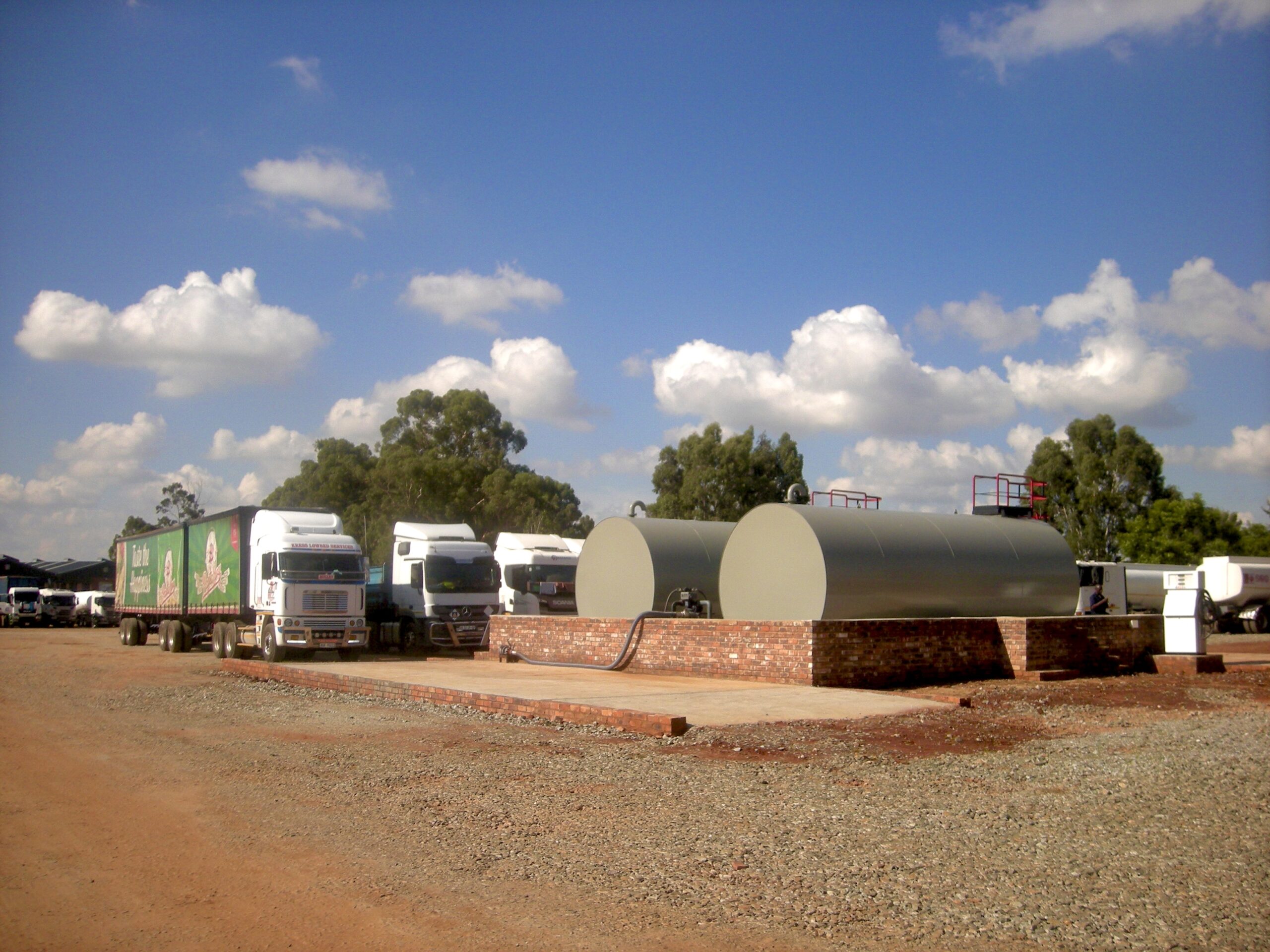 Del Oil yard with fleet and storage tanks